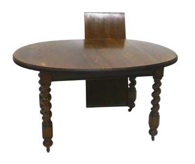 Lot 1150 - An early 20thC oak extending dining table,...