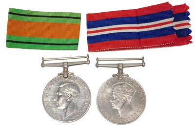 Lot 218 - A WWII Defence medal, and 1935/45 medal, in...