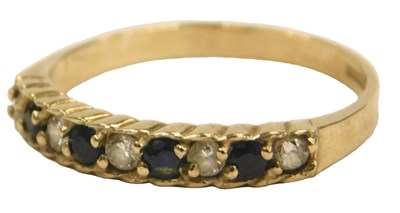 Lot 407 - A 9ct gold sapphire and CZ nine stone ring,...