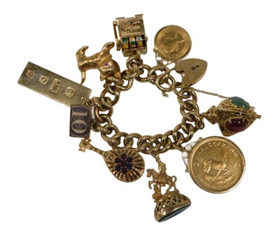 Lot 2 - A 9ct gold curb link charm bracelet, the...