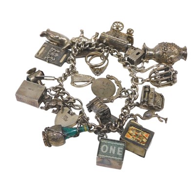 Lot 61 - A silver charm bracelet, the fine curb link...