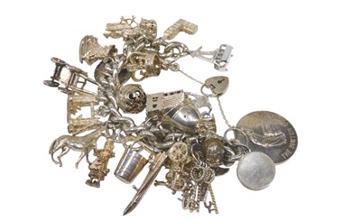 Lot 62 - A silver heavy curb link charm bracelet, with...
