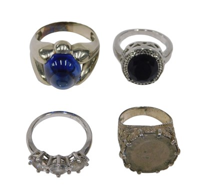 Lot 63 - Four silver dress rings, comprising a three...