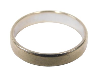 Lot 28 - An 18ct white gold wedding band, of plain...