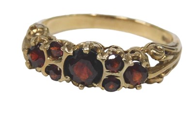 Lot 557 - A 9ct gold garnet dress ring, set with seven...