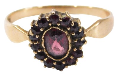 Lot 542 - A mid 20thC garnet cluster ring, the oval cut...