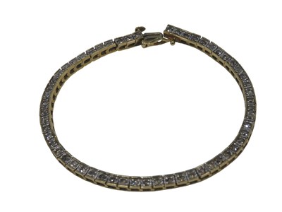 Lot 534 - A diamond set line bracelet, each link set...