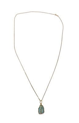 Lot 29 - A turquoise pendant and chain, the rough cut...