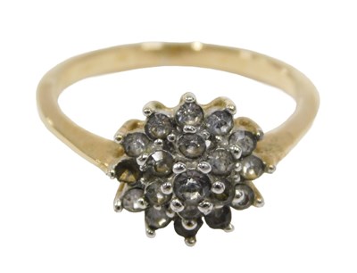 Lot 46 - A cluster dress ring, set with layered halo of...