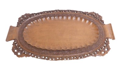 Lot 618 - A heavily carved Eastern tray, of shaped oval...