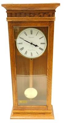 Lot 909 - A late 20thC light oak cased wall clock, the...