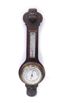 Lot 913 - An oak stained barometer and thermometer, 54cm...