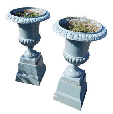 Lot 986 - A pair of cast iron garden urns, each with...