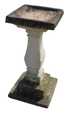 Lot 990 - A 20thC stone bird bath, with a square top on...