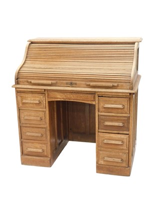 Lot 1023 - An early 20thC light oak twin pedestal roll...