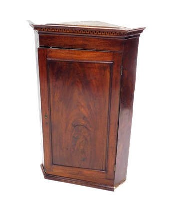 Lot 1054 - An early 19thC mahogany hanging corner cabinet,...