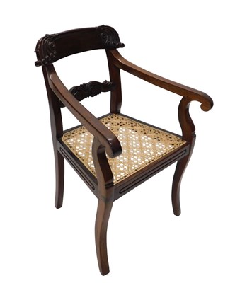 Lot 1058 - A heavily carved Regency style carver...