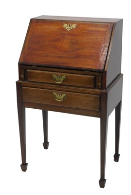 Lot 1064 - A George III style mahogany bureau on...