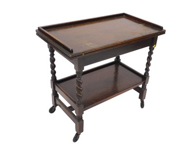 Lot 1077 - An early 20thC oak dining room trolley, with a...