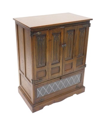 Lot 1092 - An Old Charm oak television cabinet, of...