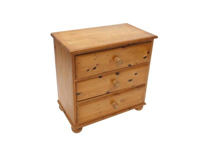 Lot 1100 - A 20thC pine chest, of three long drawers, of...