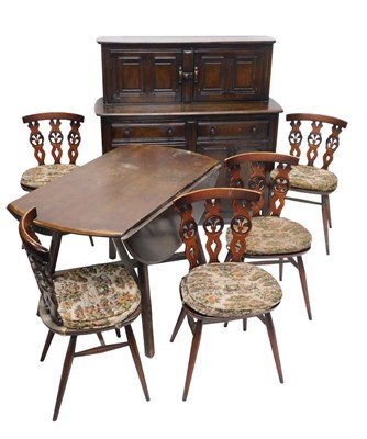 Lot 1123 - An Ercol dark elm dining room...