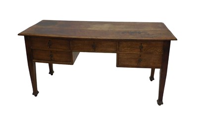 Lot 1135 - An early 20thC oak desk, the plain top raised...